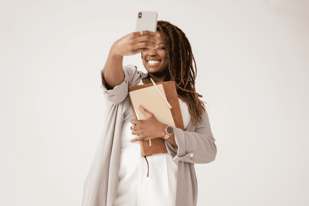 A woman with a phone learning how to take a professional photo of yourself