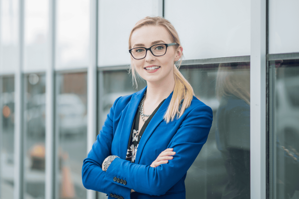 A happy woman wondering about taking a LinkedIn photo