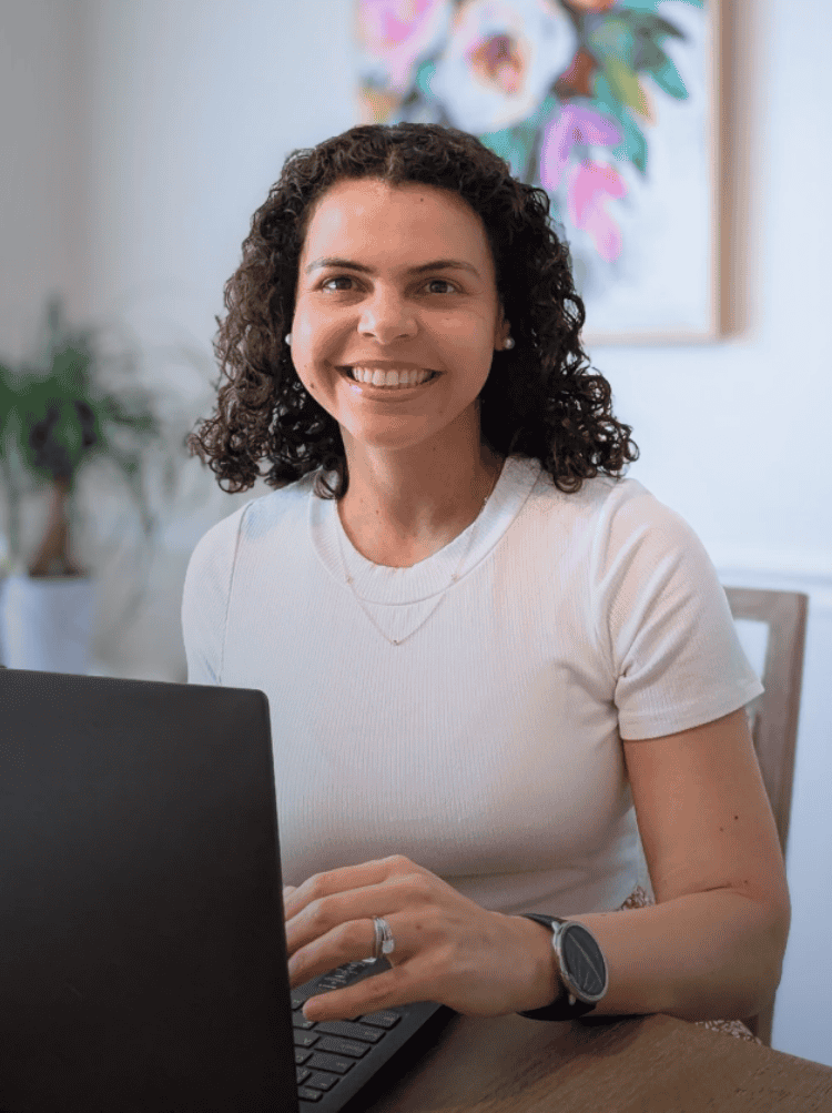 Ana Goehner at her desk with a laptop researching Asynchronous LinkedIn Networking for managers and directors.